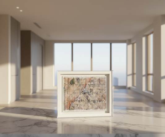 Framed artwork on a marble floor with large windows in the background