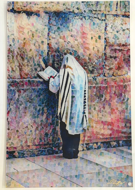 Person in prayer attire standing in front of a colorful wall.